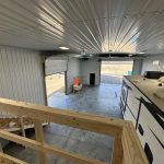 angle from balcony looking onto camper and out both garage doors